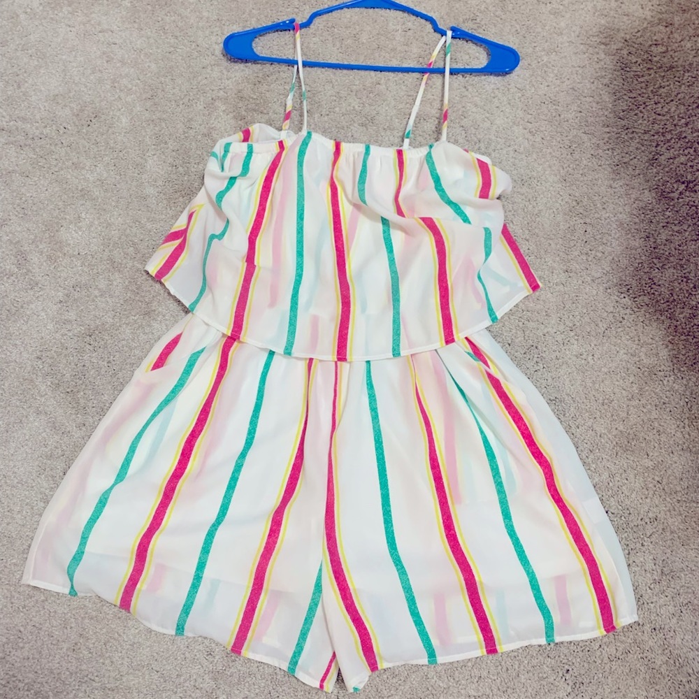 White a romper with green, pink and yellow stripes